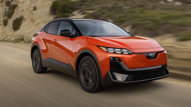 Front 3/4 view of an orange 2026 Subaru Uncharted driving