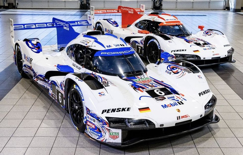 two porsche race cars displayed indoors