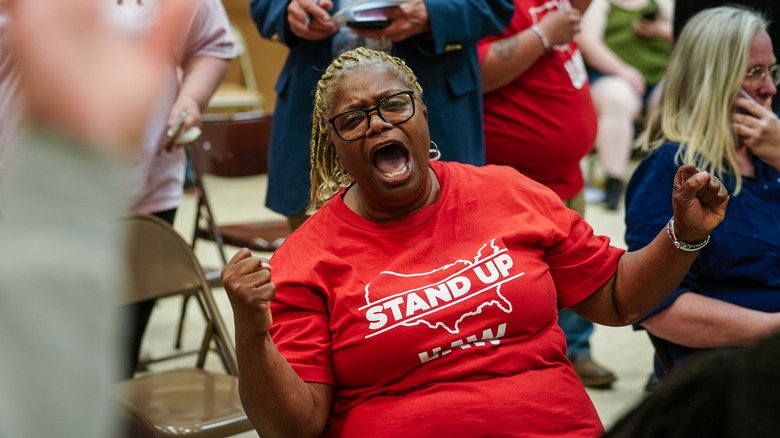 A Volkswagon employee celebrates as results of the unionization vote trickle in at a United Auto Workers vote watch party on April 19, 2024 in Chattanooga, Tennessee.